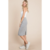 Woman wearing stylish gray knit midi pencil skirt dress paired with white tank top and sneakers