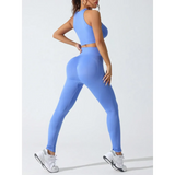 Trendsi stylish high waisted gym leggings set in blue worn by a woman with white sneakers