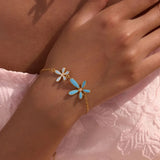 Trendsi summer beach necklace and bracelet set with gold chain and blue white flower charms on wrist