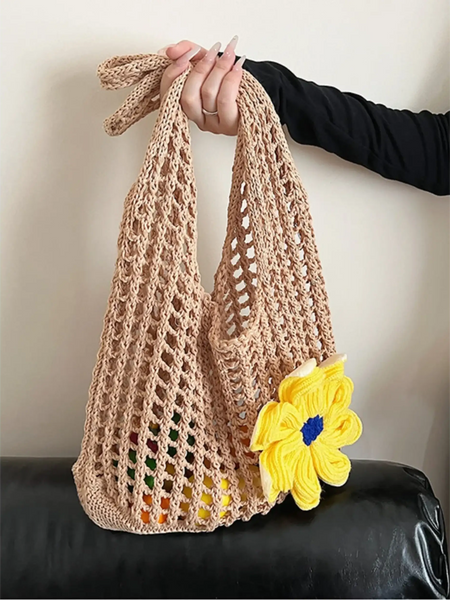 Babe Beachwear summer crochet tote 2025 in beige with a yellow flower held by hand