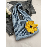 Babe Beachwear summer crochet tote 2025 in light blue with a large yellow flower accessory