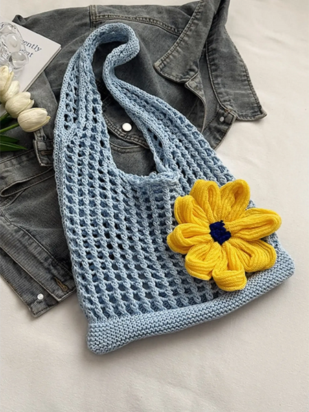 Babe Beachwear summer crochet tote 2025 in light blue with a large yellow flower accessory