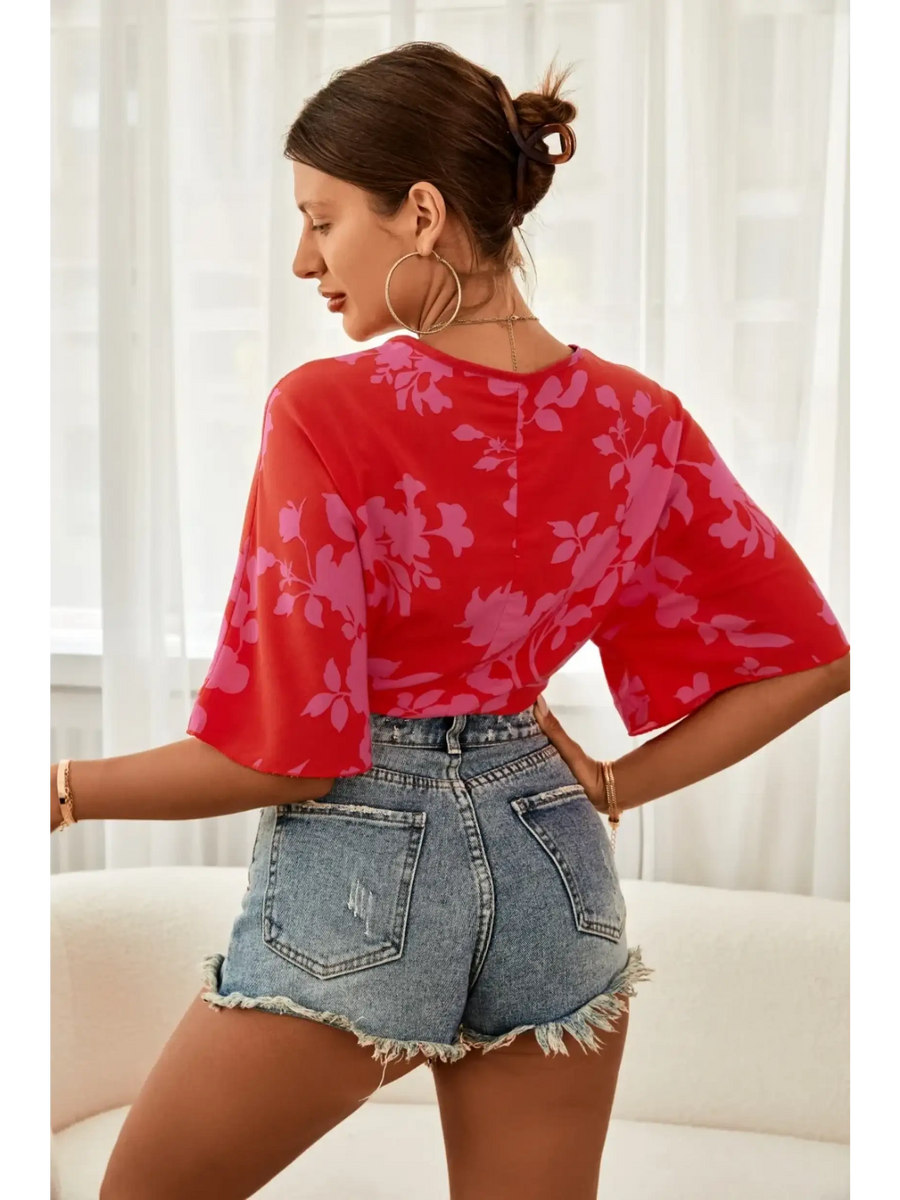 Babe Beachwear of woman wearing summer floral tie front blouse in red with purple floral pattern