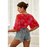 Babe Beachwear of woman wearing summer floral tie front blouse in red with purple floral pattern