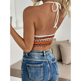 Back view of woman wearing Babe Beachwear Summer Halter boho crochet crop top with blue denim jeans