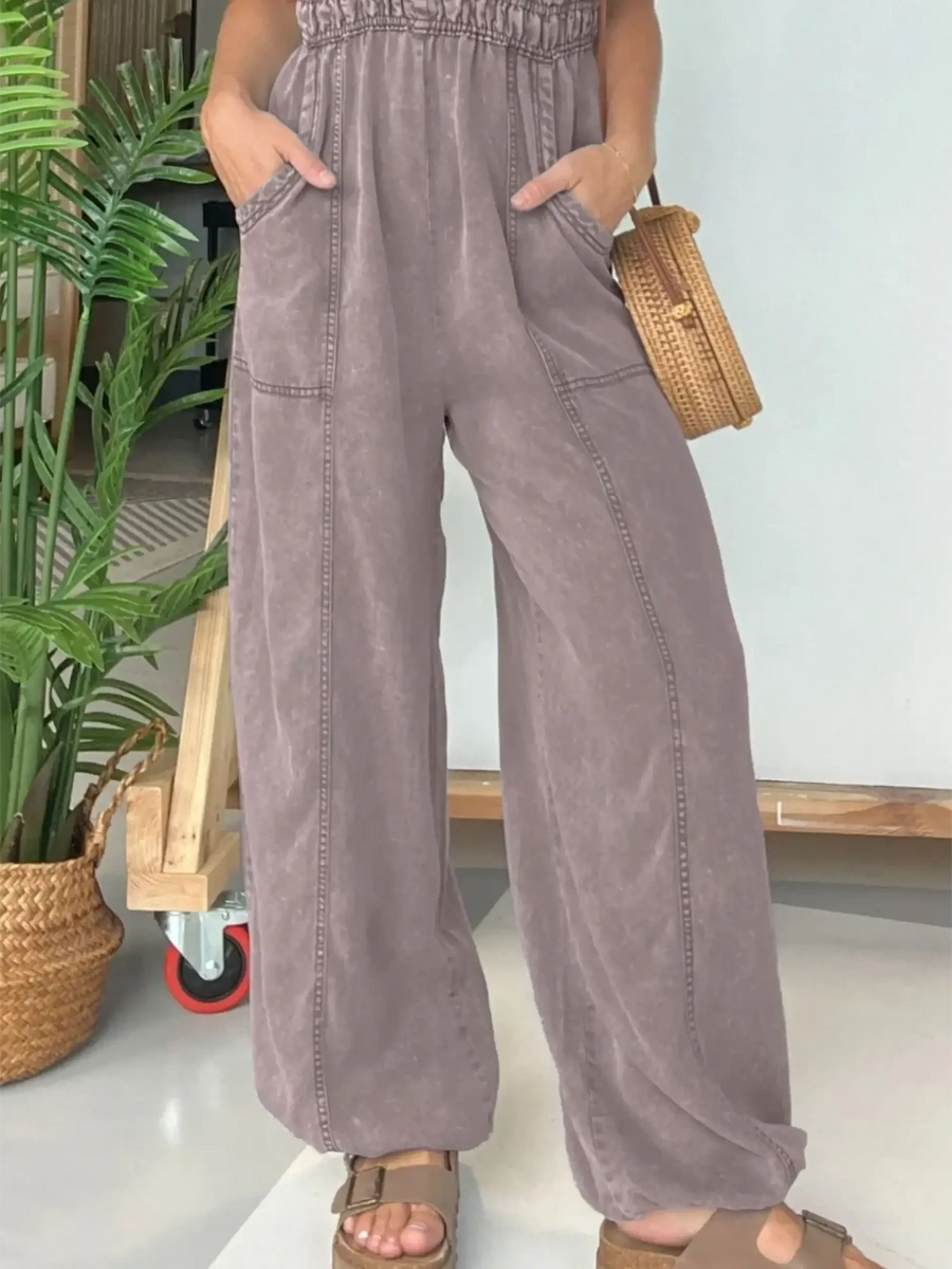 Babe Beachwear spaghetti strap summer jumpsuit in soft purple with wide legs and front pockets