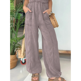 Babe Beachwear spaghetti strap summer jumpsuit in soft purple with wide legs and front pockets
