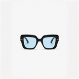 Black-framed sunglasses with blue lenses perfect for beach vacations and beach styles