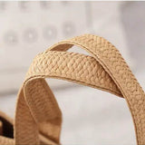 Close-up of woven straps on a Babe Beachwear Super Boho Fringe Woven Tote bag in natural beige color