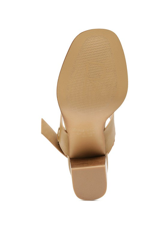 Bottom view of Rag Company tan slingback block heel sandals showing sole texture and heel shape