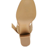 Bottom view of Rag Company tan slingback block heel sandals showing sole texture and heel shape