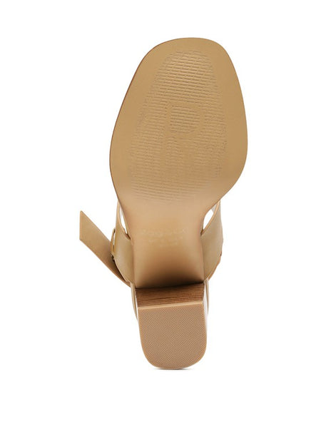 Bottom view of Rag Company tan slingback block heel sandals showing sole texture and heel shape