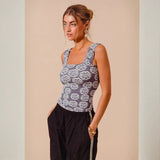 Woman wearing a floral-patterned tank top from Bloom in Style Gray Collection