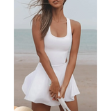 Trendsi white Criss Cross Cutout Tennis Skort Dress worn on the beach with sleeveless design