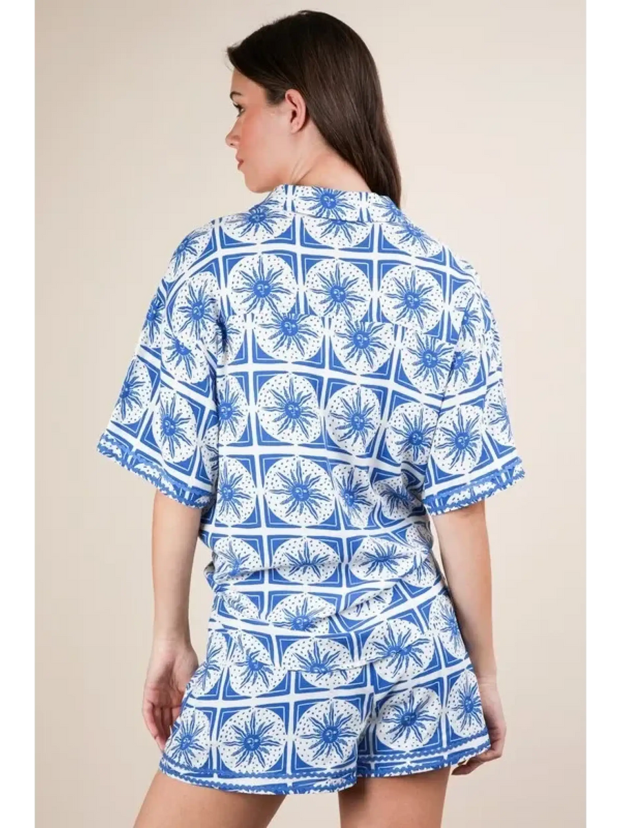 Back view of tropical blue shorts set by Babe Beachwear featuring blue and white patterned short sleeves and shorts