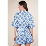 Back view of tropical blue shorts set by Babe Beachwear featuring blue and white patterned short sleeves and shorts
