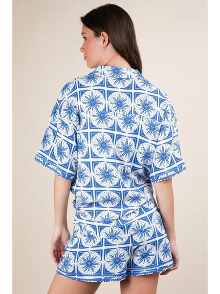 Back view of tropical blue shorts set by Babe Beachwear featuring blue and white patterned short sleeves and shorts