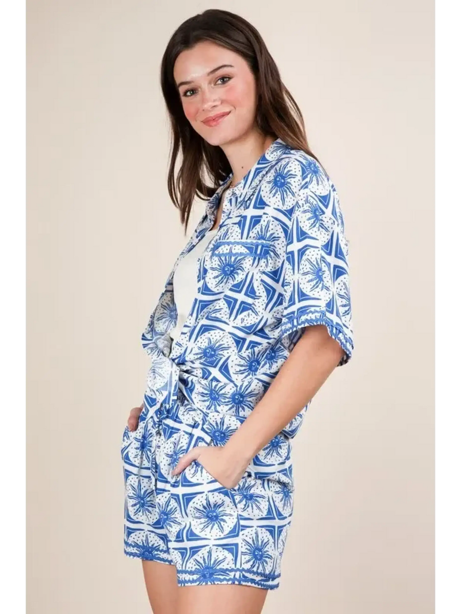 Woman wearing Babe Beachwear tropical blue shorts set with floral print and relaxed fit