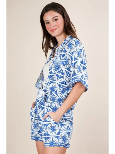 Woman wearing Babe Beachwear tropical blue shorts set with floral print and relaxed fit