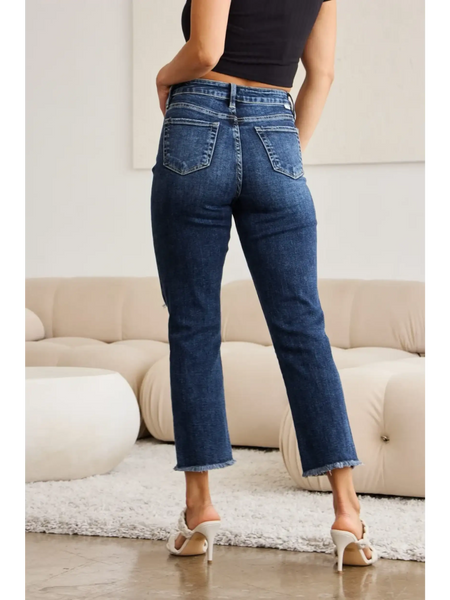 Trendsi tummy control high waist jeans in dark blue denim worn by woman standing indoors