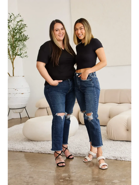 Two women wearing Trendsi tummy control high waist jeans with ripped knees paired with black tops indoors