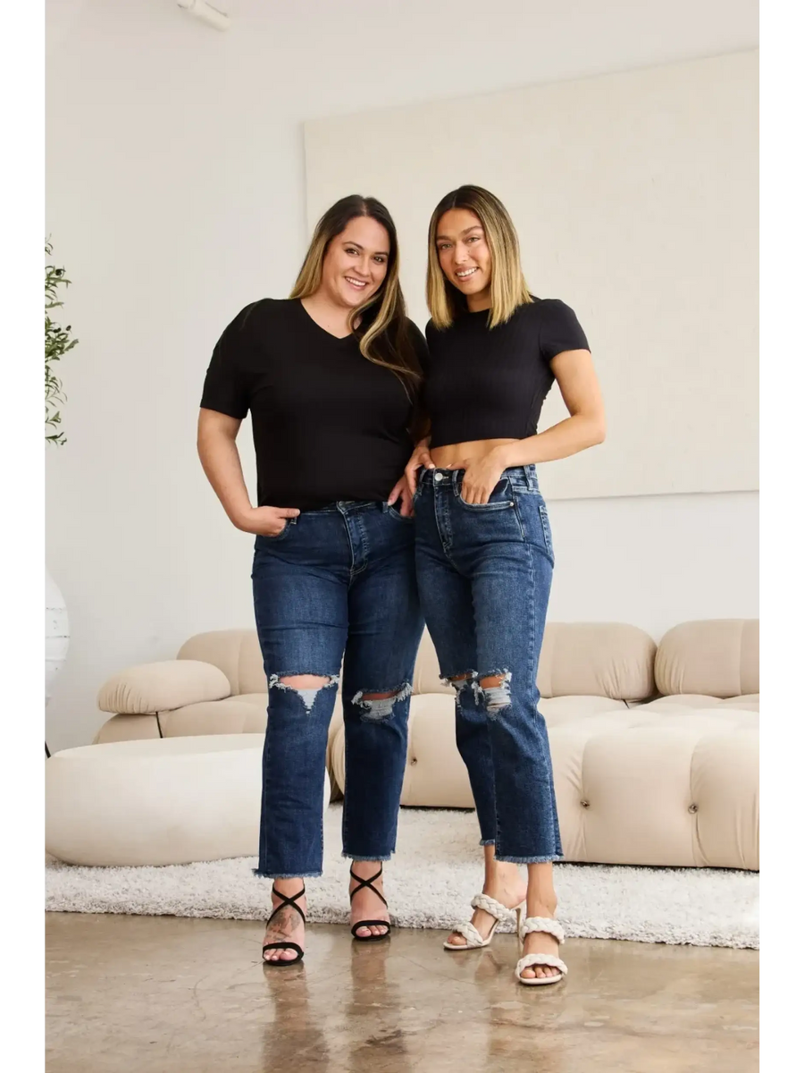 Two women wearing Trendsi tummy control high waist jeans with ripped knees and black tops indoors
