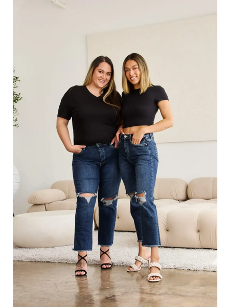 Two women wearing Trendsi tummy control high waist jeans with ripped knees and black tops indoors