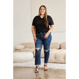Trendsi tummy control high waist jeans in dark blue with distressed knees worn by smiling woman