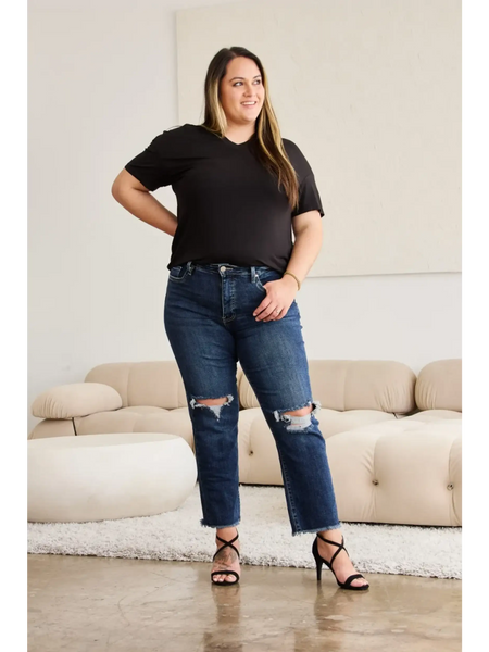 Trendsi tummy control high waist jeans in dark blue with distressed knees worn by woman with black top and heels