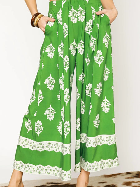green wide leg pants featuring Umgee floral palazzo pants design with white floral patterns and lace trim