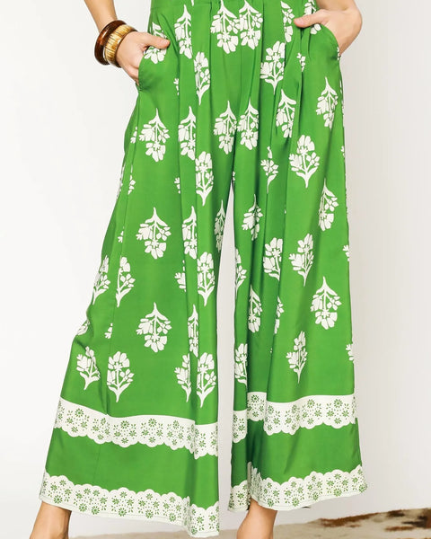 green wide leg pants featuring Umgee floral palazzo pants design with white floral patterns and lace trim