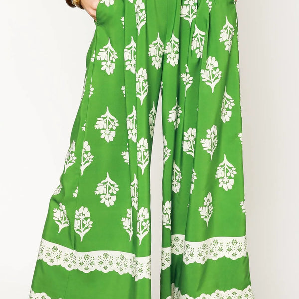 green wide leg pants featuring Umgee floral palazzo pants design with white floral patterns and lace trim