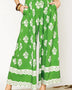 green wide leg pants featuring Umgee floral palazzo pants design with white floral patterns and lace trim