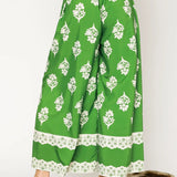 green wide leg pants featuring Umgee floral palazzo pants design with white floral print and lace trim