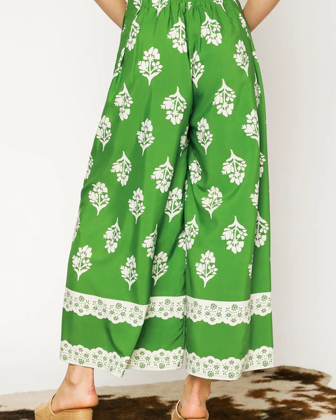 green wide leg pants featuring Umgee floral palazzo pants design with white floral print and lace trim