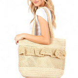 Artini Accessories uniqe ruffle straw bag carried by woman with long blonde hair in white outfit