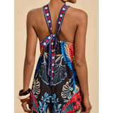 Babe Beachwear colorful floral vacation halter jumpsuit outfit with tie-back straps on model