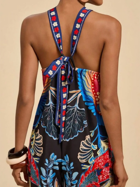 Babe Beachwear colorful floral vacation halter jumpsuit outfit with tie-back straps on model