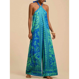 Babe Beachwear blue and green vacation halter jumpsuit outfit with wide legs and floral patterns