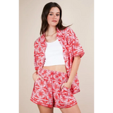 Babe Beachwear vacation printed top and shorts outfit with red and white floral pattern on model