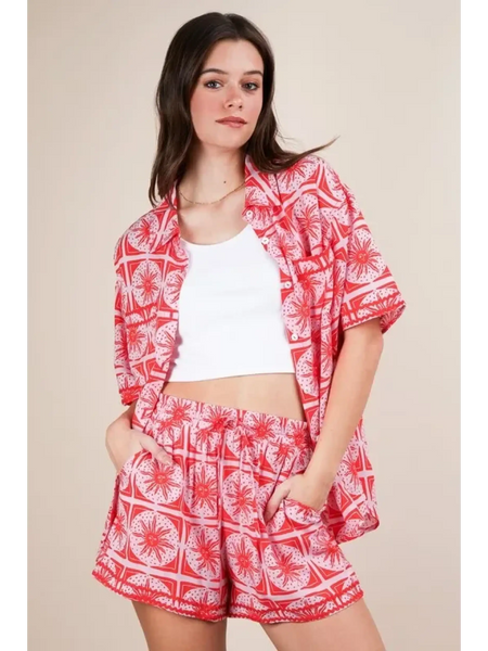 Babe Beachwear vacation printed top and shorts outfit with red and white floral pattern on model