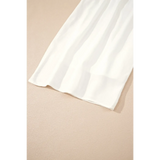 White vacation resort wide leg trousers by Trendsi laid flat on beige surface