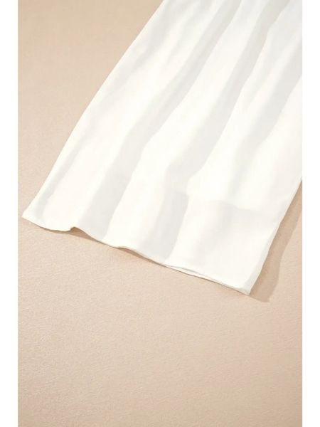White vacation resort wide leg trousers by Trendsi laid flat on beige surface