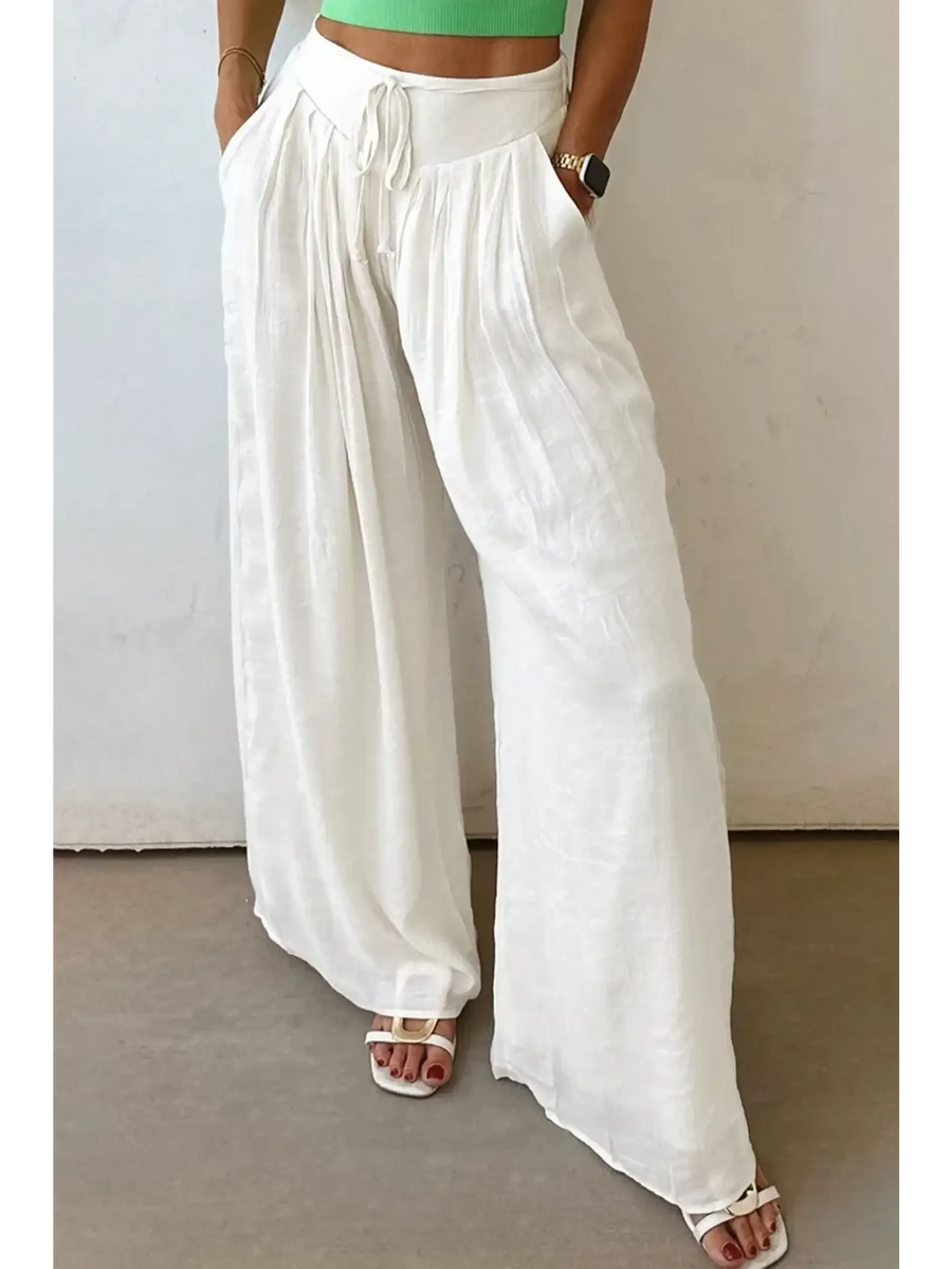 White vacation resort wide leg trousers from Trendsi worn with sandals and a green crop top