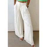 White vacation resort wide leg trousers from Trendsi worn with sandals and a green crop top