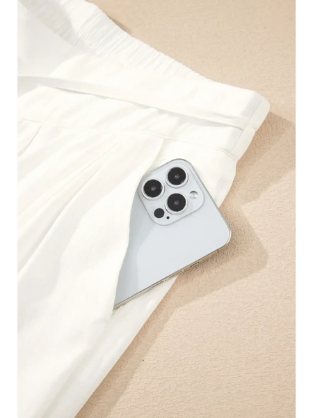 White vacation resort wide leg trousers from Trendsi with a side pocket holding a smartphone