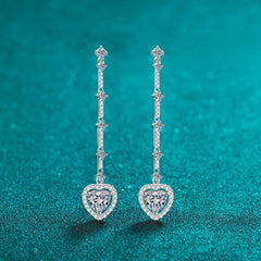 Trendsi 2 carat moissanite heart earrings with delicate dangling design on teal background