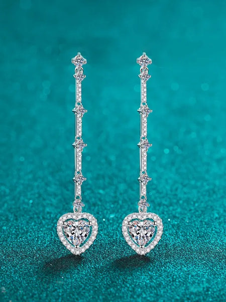 Trendsi 2 carat moissanite heart earrings with delicate dangling design on teal background