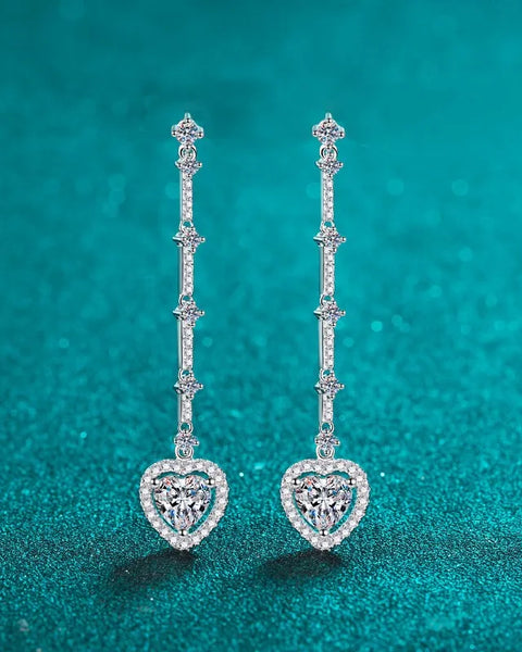 Trendsi 2 carat moissanite heart earrings with delicate dangling design on teal background