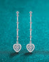 Trendsi 2 carat moissanite heart earrings with delicate dangling design on teal background